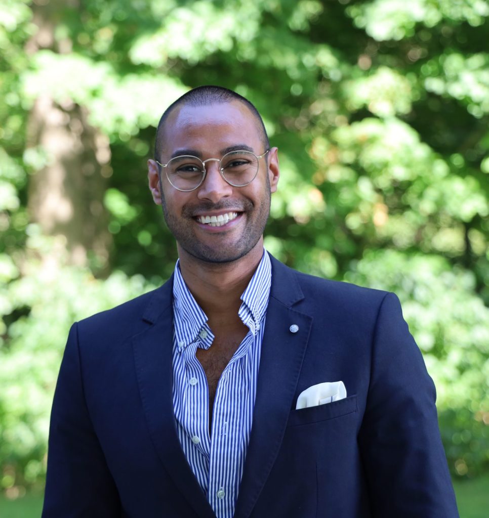 A smiling man in a blue suit